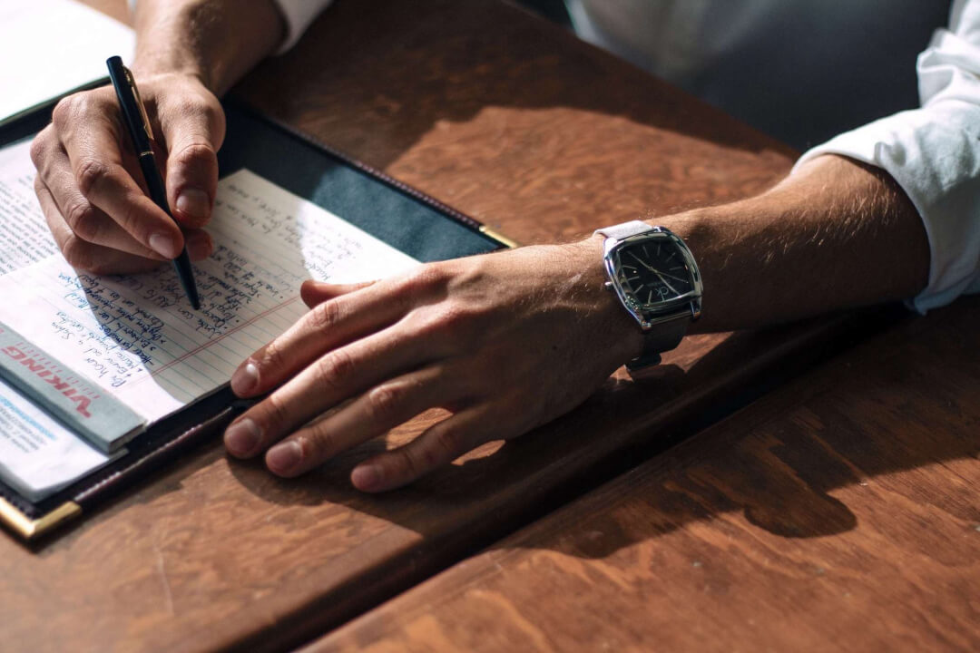 Business owner writing down notes on paper.